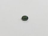 a green tourmaline stone on a white surface