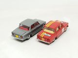 two toy cars that are next to each other on a white surface