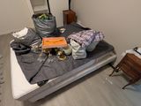 a bed that has a lot of stuff on top of it