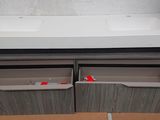 a sink and two drawers in the bathroom