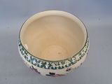 a white bowl with blue and pink flowers on it