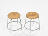pair of industrial stools with wooden seat and metal legs