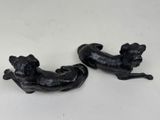 two black sculptures of dogs on a white surface