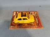 a yellow toy car sitting on top of a magazine