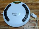 a robot that is sitting on the floor next to a charger