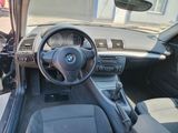 a dashboard of a car with a steering wheel and dashboard controls