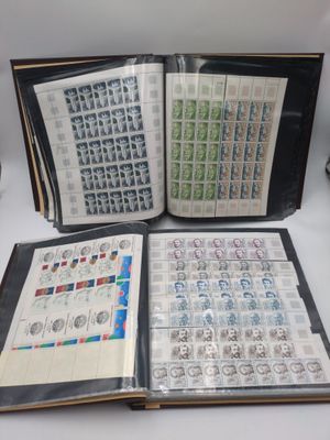 an open book sitting on top of a table covered in stamps