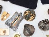 many different types of metal buttons on a table