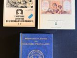 three books sitting on a table next to each other on top of a table