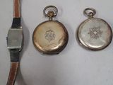 three different types of watches sitting on a white surface