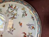 a plate with a bird design on it on a table