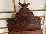 a wooden shelf with a carved angel on it