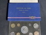 a box of coins sitting on top of a table
