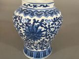 a blue and white vase sitting on a table