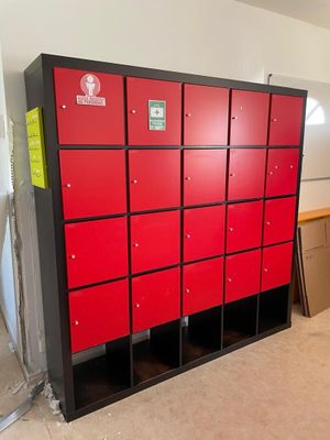 many red lockers in a room with a white wall