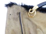 a close up of a purse with a black handle
