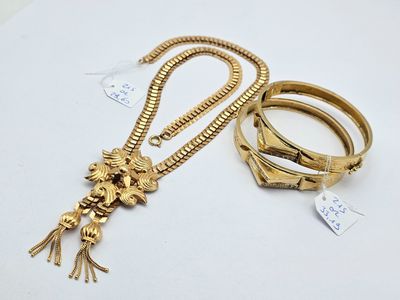 deux bracelets en or et un collier orné d'une tête de lion
