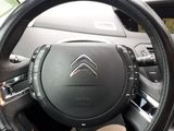 the steering wheel of a car with a black leather steering cover