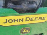 a close up of a john deere logo on the front of a tractor