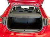 the back of a red car with its trunk open and luggage in the trunk