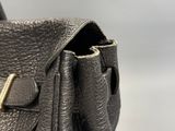 the inside of a black purse with a gold buckle