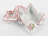a small white bowl with a pink bow on top of it
