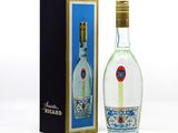 a bottle of vodka next to a box on a white surface