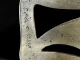 a close up of a metal object on a black surface