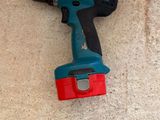 a drill that is laying on the floor next to a piece of wood