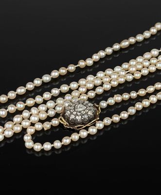 a pearl and diamond necklace with a clasp