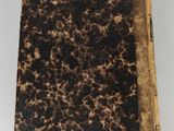 an old book sitting on top of a white table