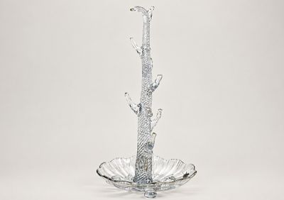 a glass vase with a bird on top of it