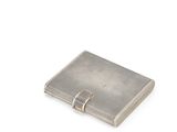 an image of a silver cigarette case sitting on top of a white surface