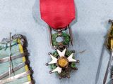 three medals and a pair of scissors sit on a blue surface