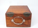 a small wooden box with a metal handle on it