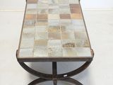 an image of a table with a tile top and metal legs
