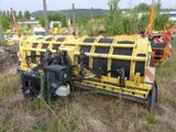 a yellow and black truck that is parked in the grass