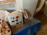a machine that is sitting next to a pile of nuts