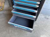 a close up of a tool cabinet with drawers on top of it