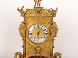 a gold clock that is sitting on top of a table