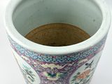 a close up of a vase on a white surface