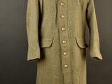 an image of a coat on a mannequin stand on a black background