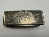 an old silver cigarette case with a picture of a man and woman on it