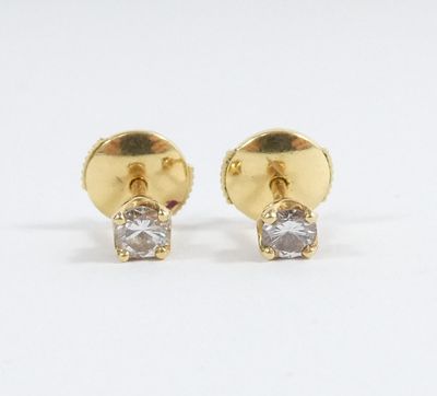 a pair of gold and diamond earrings on a white background