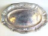 a silver plate on a table with a white background
