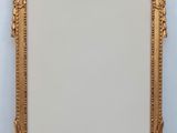 an antique gold frame with a decorative design on it