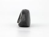 a close up of a small black object on a white surface