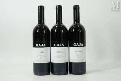 three bottles of wine sitting on top of a white table