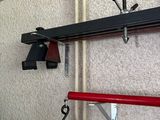 a picture of a wall mounted rack with hooks and a pair of scissors