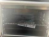 a toaster oven with a tray of food inside of it